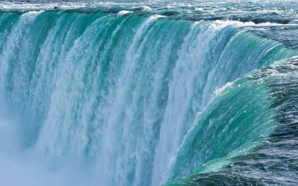 The teal water of Horseshoe Falls pouring over the brink at Niagara